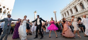 Friends and family dancing with the Hare Krishna in St Mark's square during our wedding in Venice